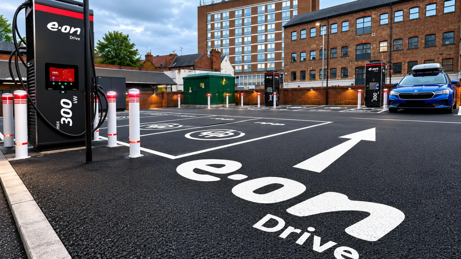 Ultra-rapid charging bays on a resurfaced urban car park at dusk, with tall charging units guarded by bollards, a green package substation behind and a car parked at the furthest unit